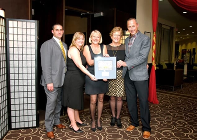 Skyline staff accept the honorary plaque at the Foundation’s Around the World Gala