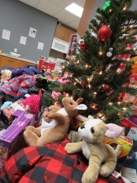 A pile of toys around a christmas tree