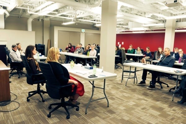 Room full of Skyline employees listening to the presentation of female leaders for international women's day