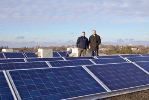 Two men stand on a rooftop