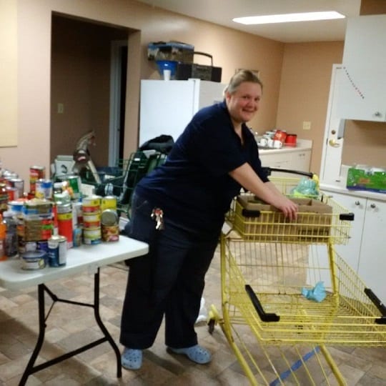 Skyline staff filling a shopping cart full of the collected food