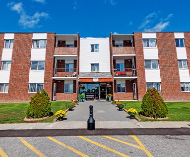 Exterior of an apartment building at 1214 Riverside Drive in Timmins, Ontario.