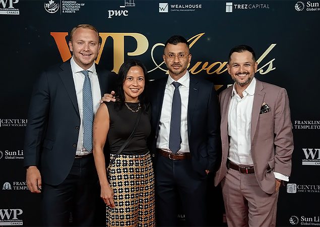 Skyline Wealth Management employees at an award gala, smiling and posing with an award trophy.